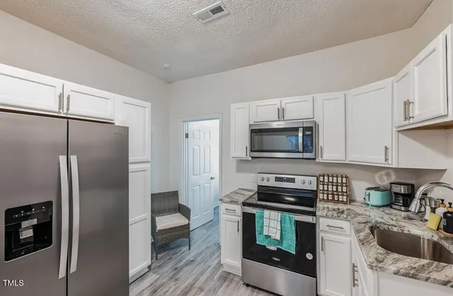 a kitchen with a refrigerator stove and microwave