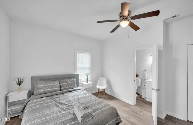 a bedroom with a bed and a ceiling fan
