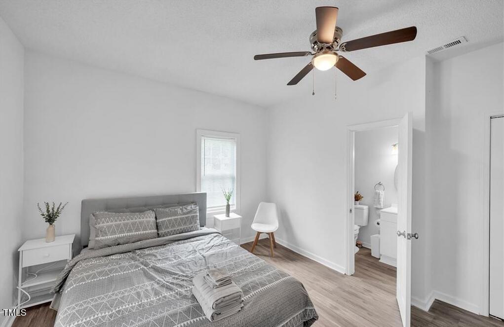 1512 Pender Street Raleigh, NC 27610 - Photo 8 of 12 a bedroom with a bed and a ceiling fan