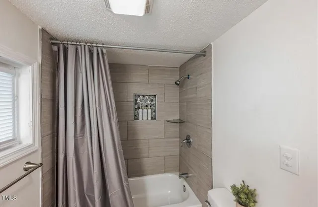 a bathroom with a shower and a toilet