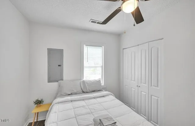 a bedroom with a bed and a window