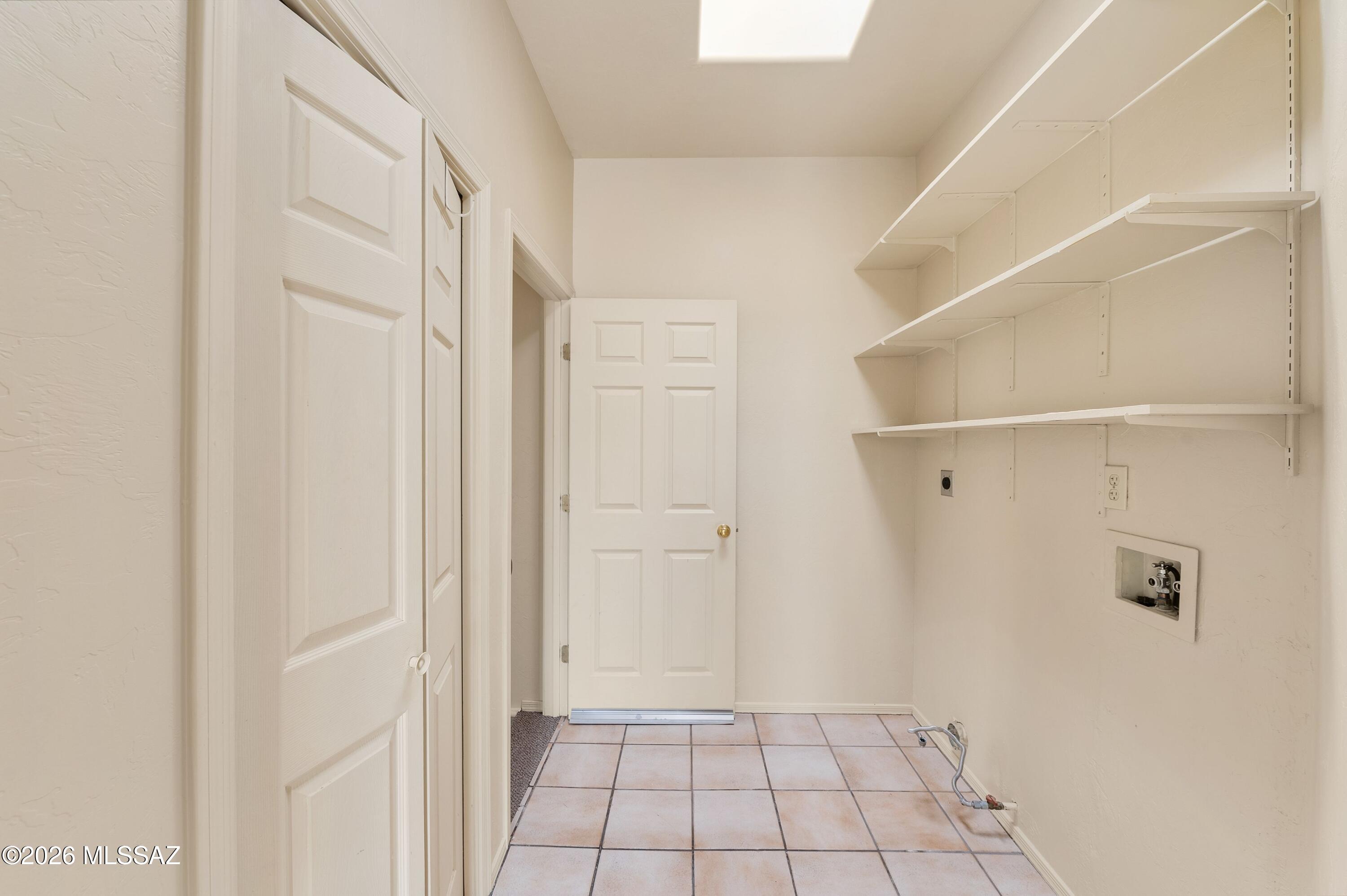 12160 East Tanque Verde Road Tucson, AZ 85749 - Photo 42 of 53 Built-in shelving and tile flooring off the kitchen hall.