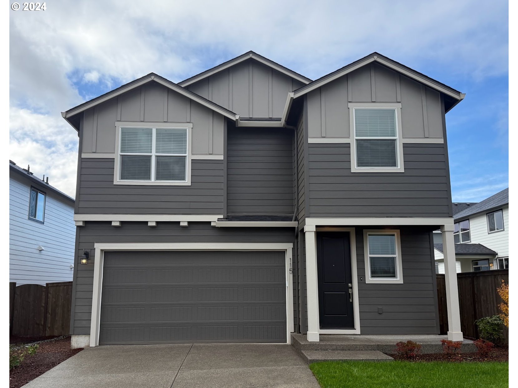 115 North 88th Drive Ridgefield, WA 98642 - Photo 1 of 32 a front view of a house with a yard and garage