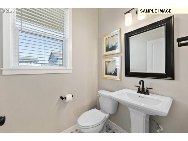 115 North 88th Drive Ridgefield, WA 98642 - Photo 7 of 32 a bathroom with a toilet sink and mirror