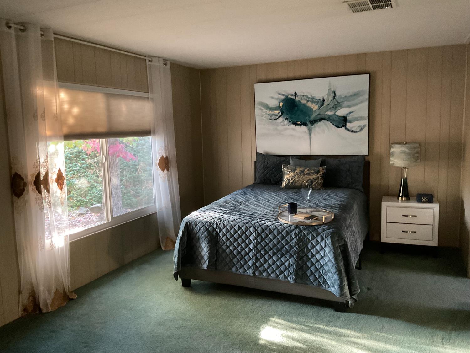 10124 Hidden Springs Drive Grass Valley, CA 95949 - Photo 20 of 27 a bedroom with a bed and a painting on the wall