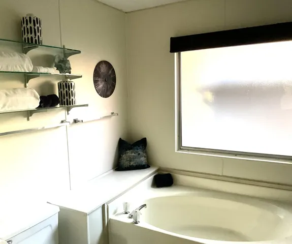 a bathroom with a bathtub and a window