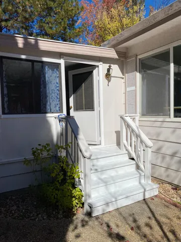 a front view of a house with plants