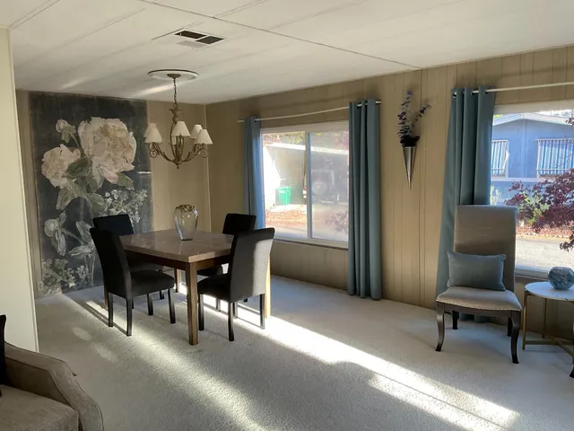 a dining room with furniture and window