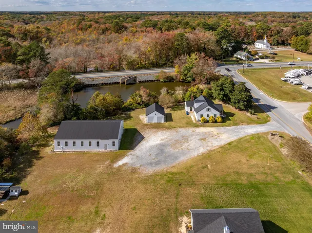 an aerial view of a house with a yard and lake view