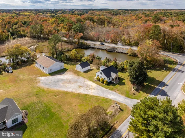 an aerial view of a house with a garden and swimming pool