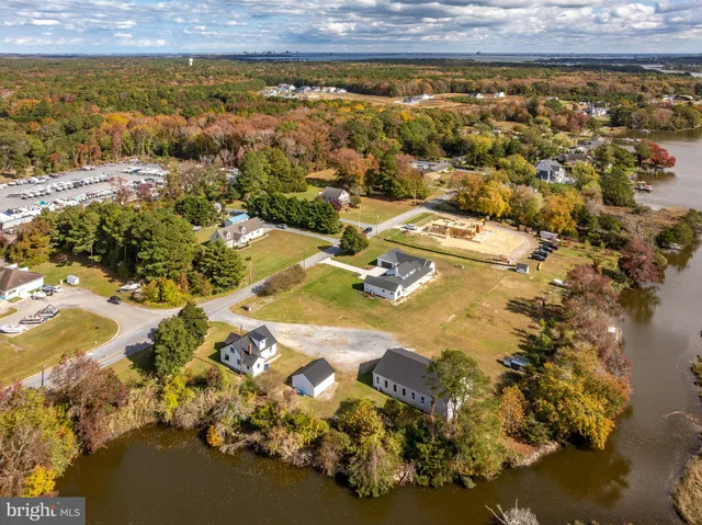 an aerial view of a house with a garden and lake view