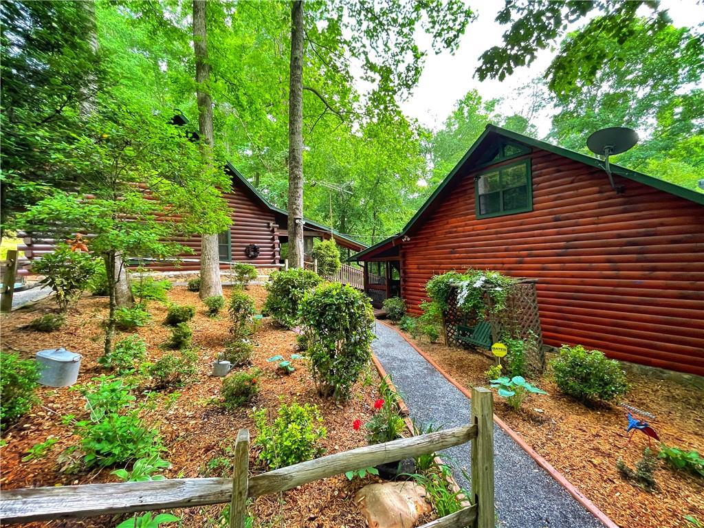 510 Weaver Road Ellijay, GA 30536 - Photo 1 of 1 a view of house with wooden walls and potted plants