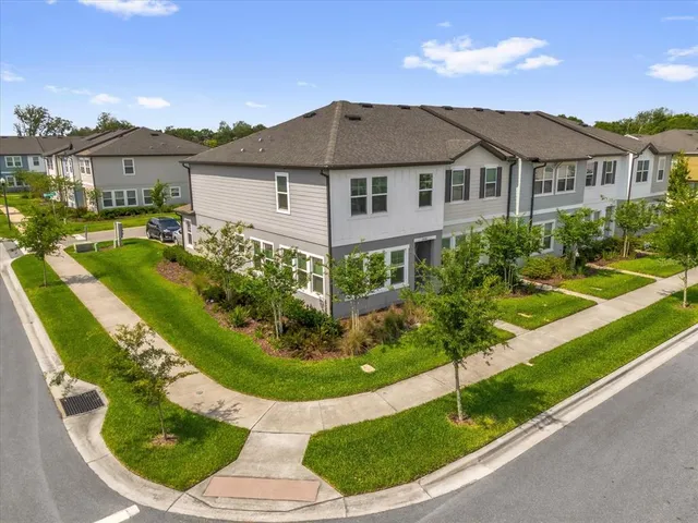 a aerial view of a house with yard and green space