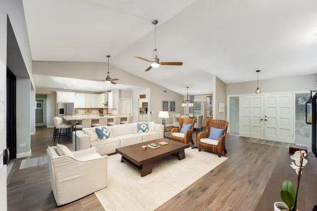 a living room with furniture and a chandelier
