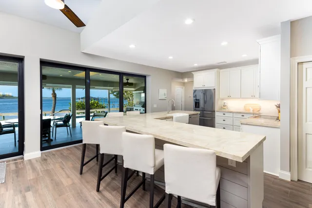 a dining room with stainless steel appliances a table and chairs