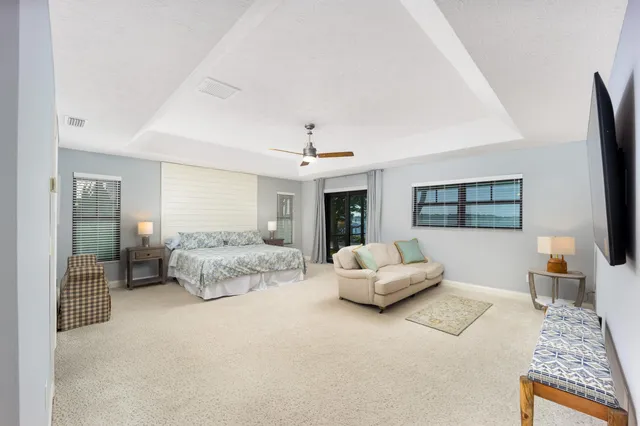 a living room with furniture and large windows