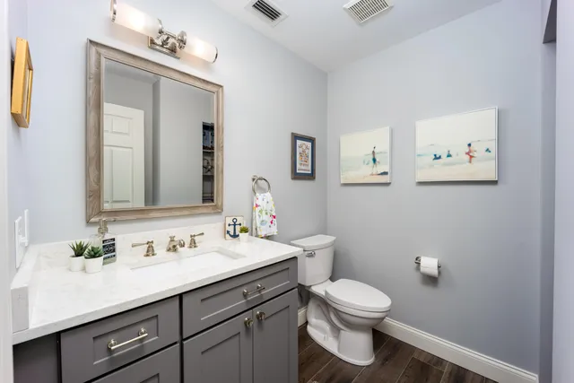 a bathroom with a toilet a sink and mirror