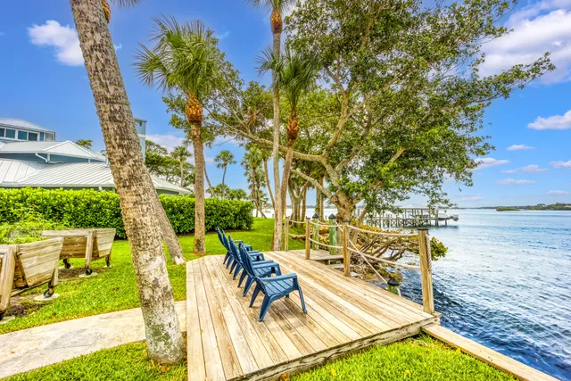 a view of yard from deck with patio
