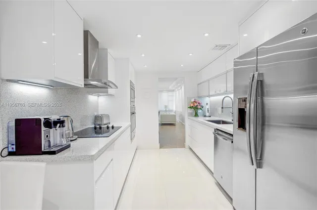 a large kitchen with stainless steel appliances granite countertop a sink and stove top oven