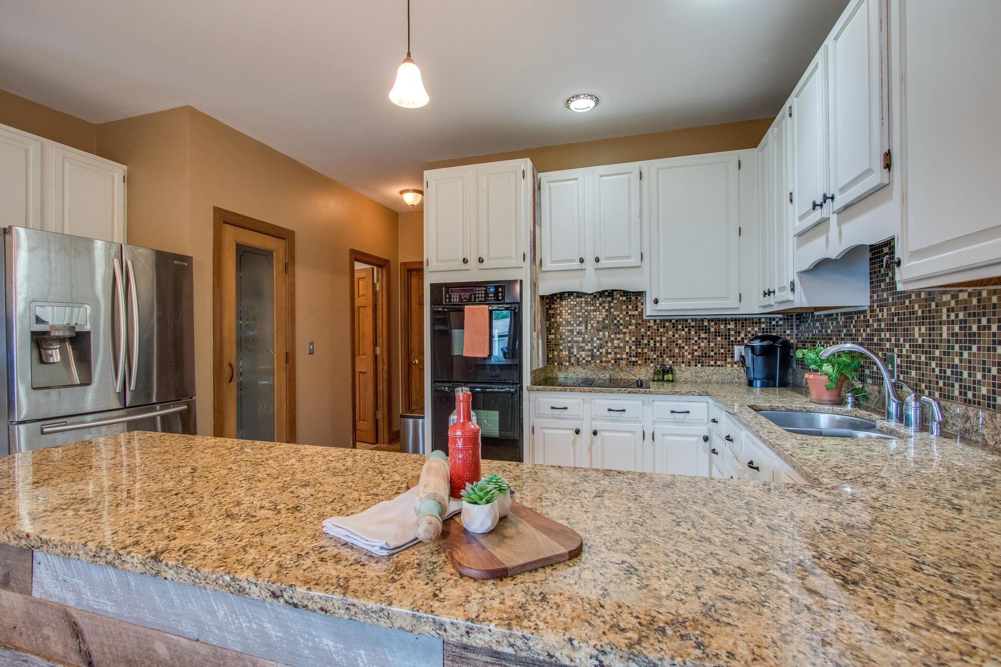 1105 Kathryn Road Mount Juliet, TN 37122 - Photo 11 of 30 a kitchen with stainless steel appliances granite countertop a sink refrigerator and cabinets