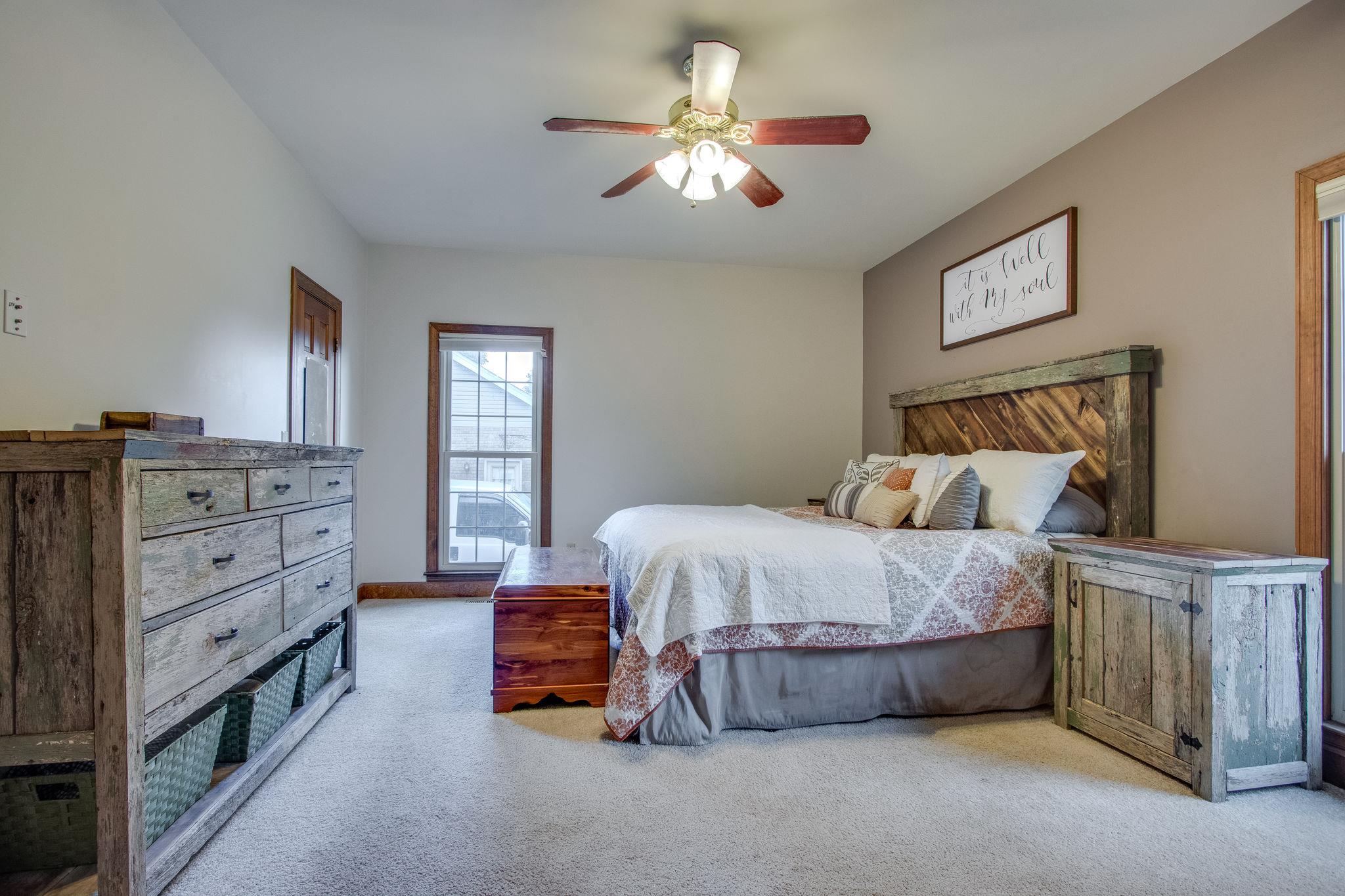 1105 Kathryn Road Mount Juliet, TN 37122 - Photo 15 of 30 a bedroom with a bed and a chandelier