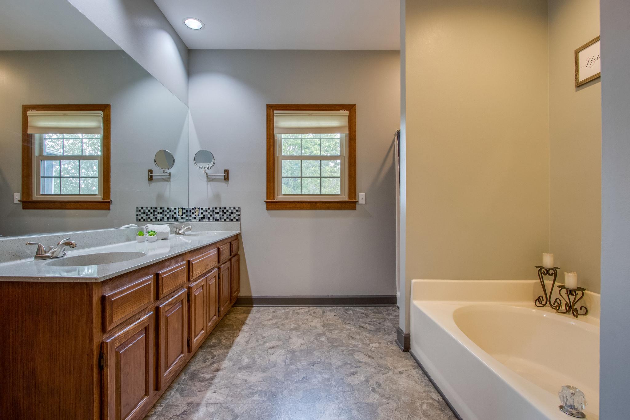 1105 Kathryn Road Mount Juliet, TN 37122 - Photo 16 of 30 a bathroom with a granite countertop tub sink and mirror