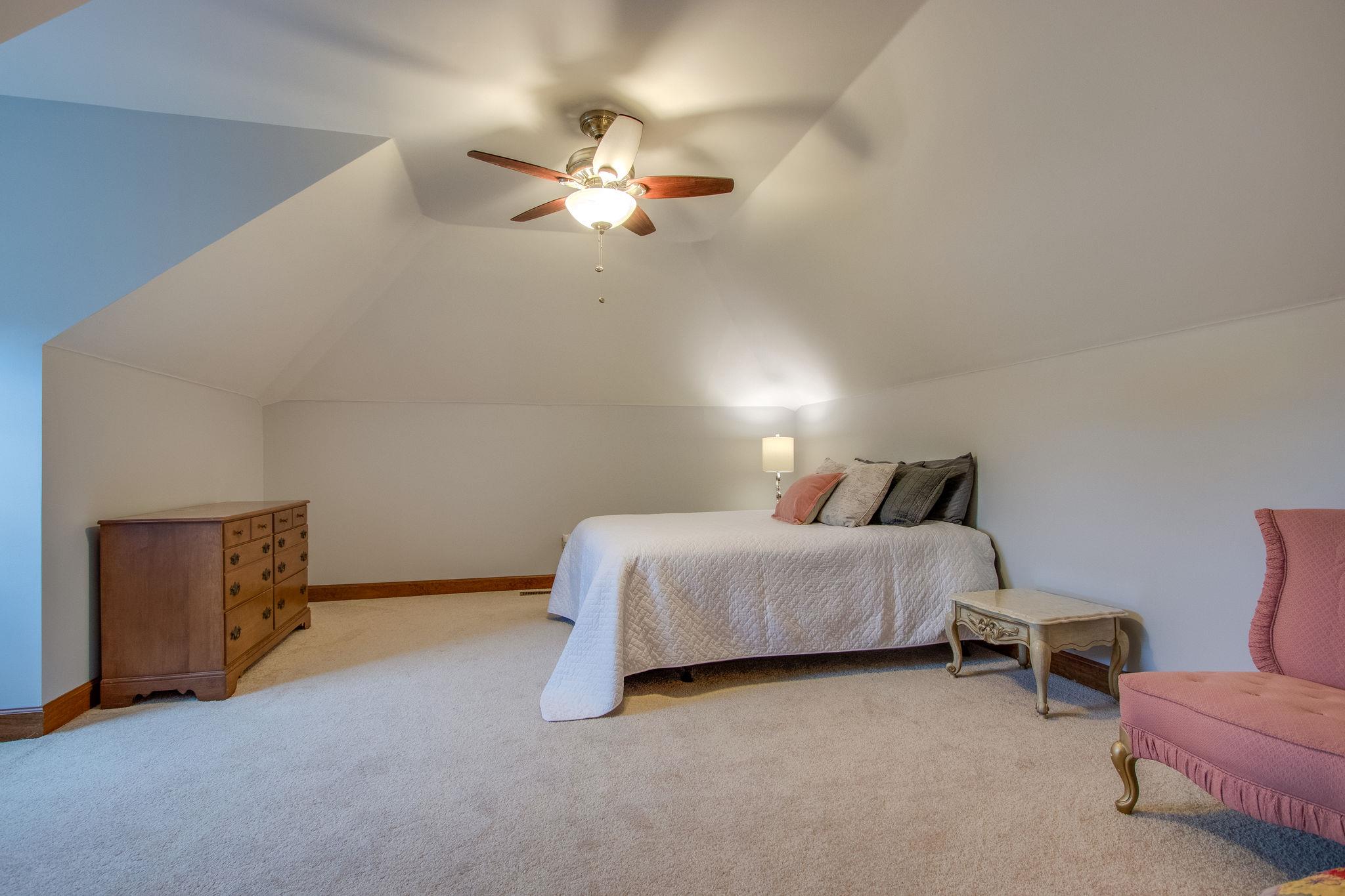 1105 Kathryn Road Mount Juliet, TN 37122 - Photo 25 of 30 a spacious bedroom with a bed and a chandelier