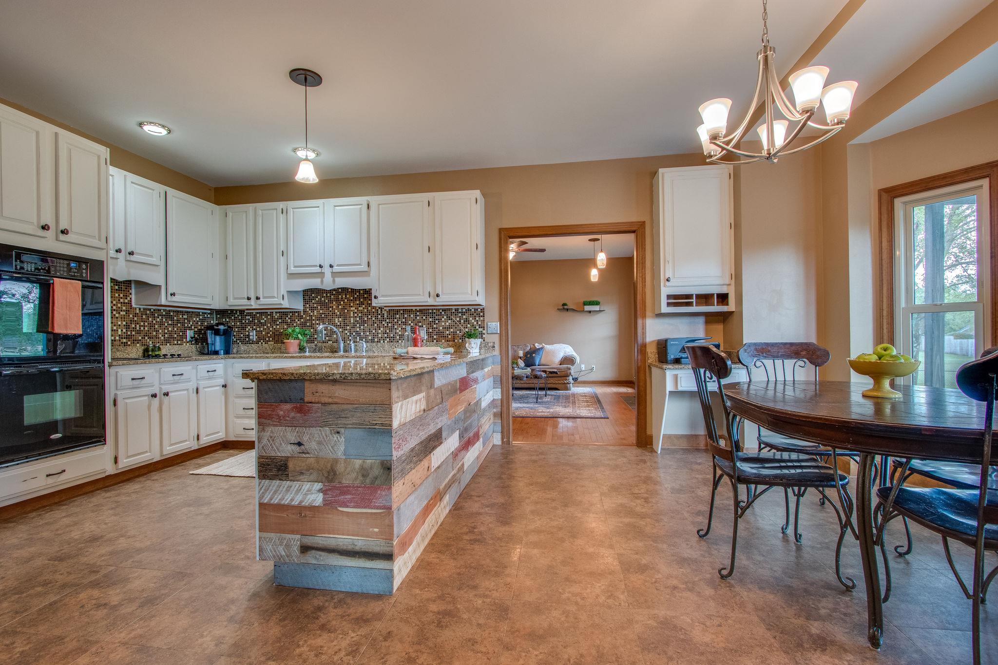 1105 Kathryn Road Mount Juliet, TN 37122 - Photo 9 of 30 a living room with kitchen island furniture and a chandelier