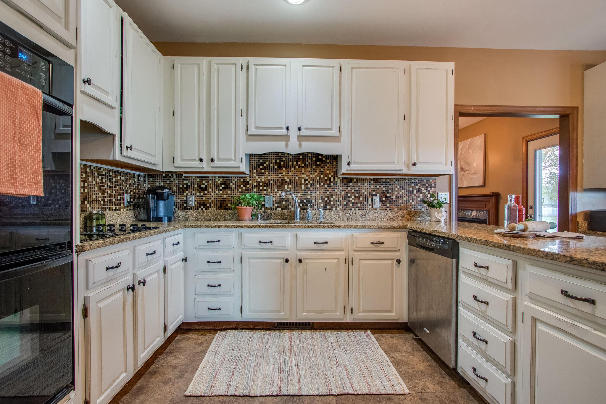 1105 Kathryn Road Mount Juliet, TN 37122 - Photo 10 of 30 a kitchen with white cabinets and white appliances