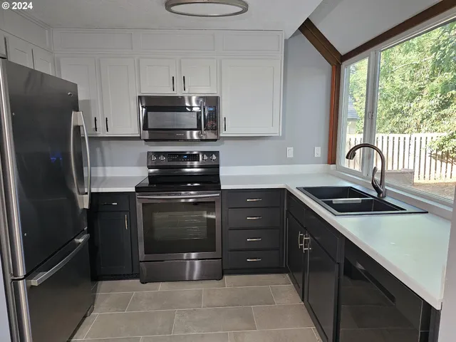 a kitchen with a refrigerator stove and sink
