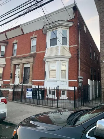 a view of a building with car parked
