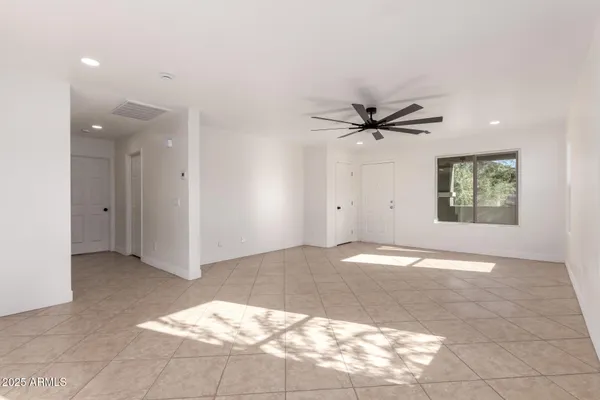 a view of a livingroom with a ceiling fan and window