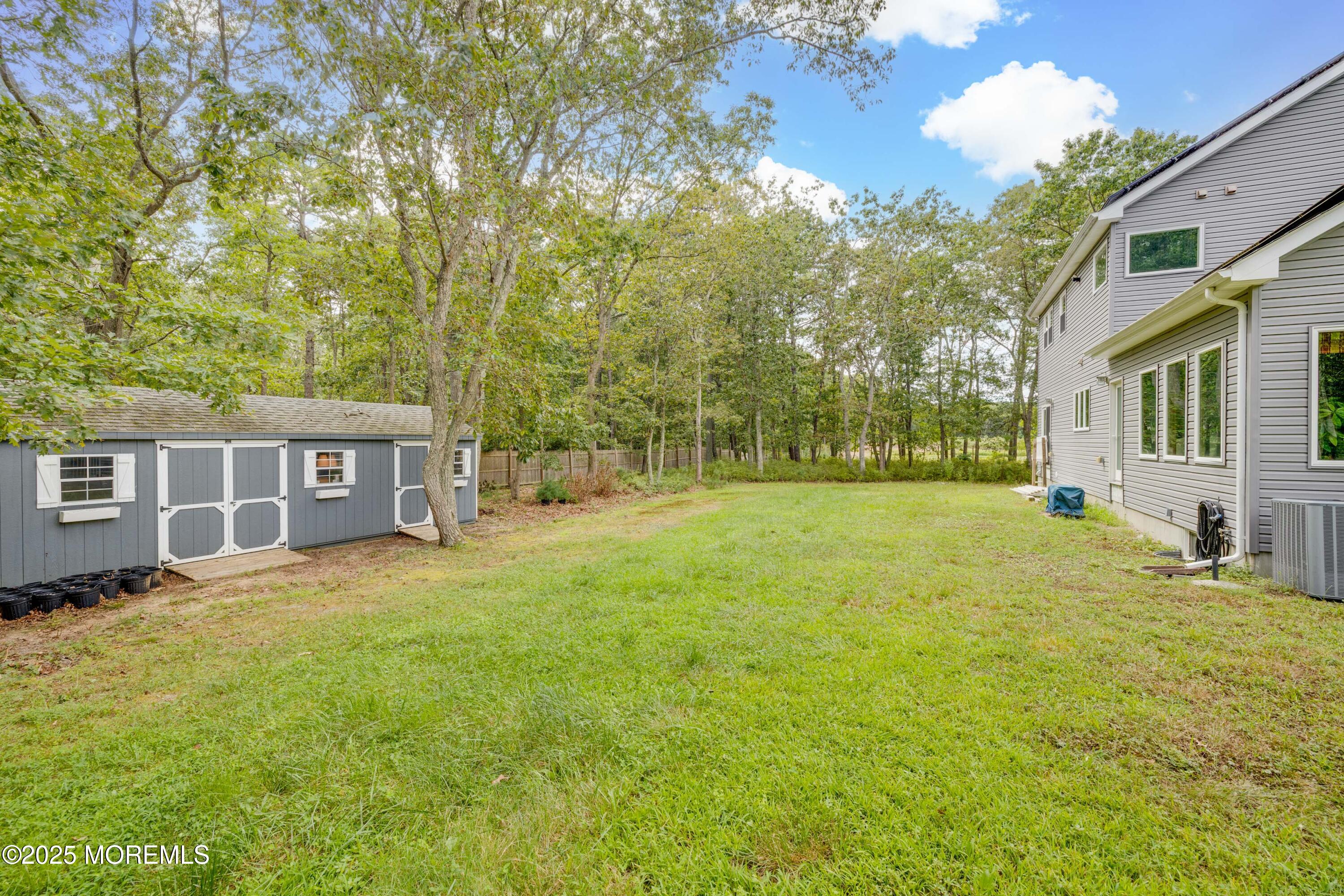 501 Newtons Corner Road Howell, NJ 07731 - Photo 28 of 29 a backyard of a house with yard and outdoor seating