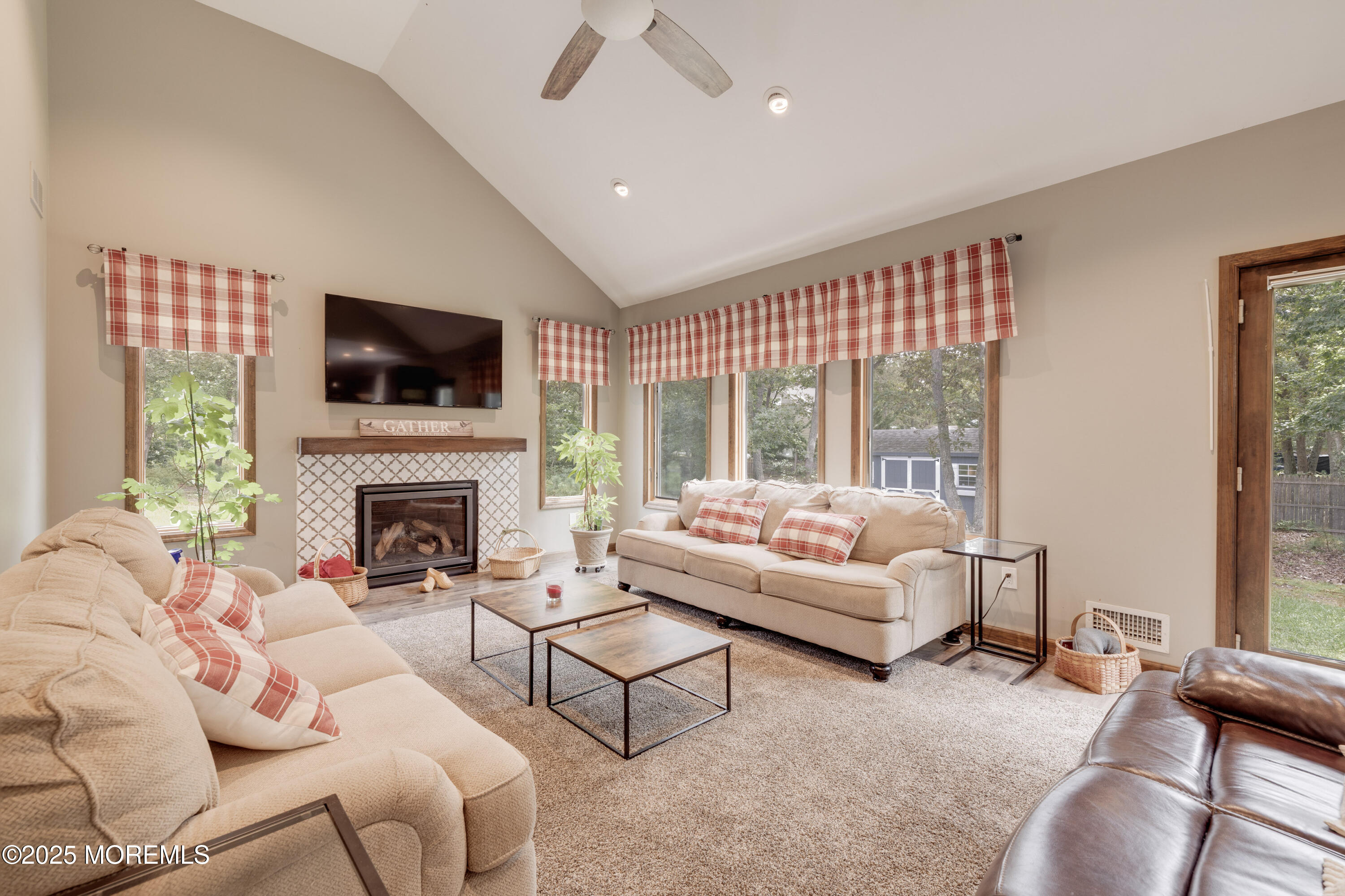 501 Newtons Corner Road Howell, NJ 07731 - Photo 10 of 29 a living room with furniture a fireplace and a flat screen tv