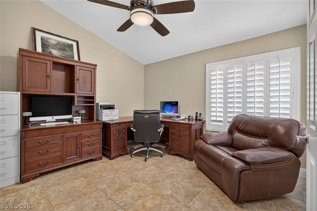 818 Manor Shores Road Henderson, NV 89002 - Photo 25 of 35 Sloped ceilings and a warm tile floor define this productive home office space.
