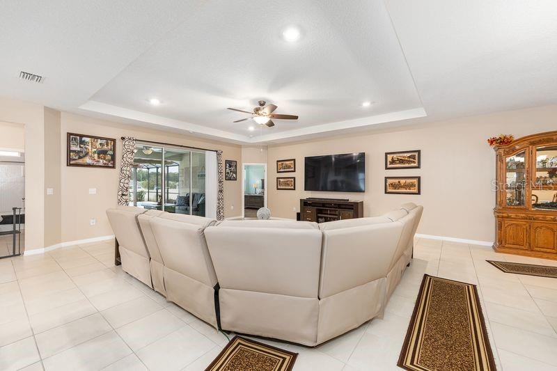 5077 Northeast 16th Street Ocala, FL 34470 - Photo 11 of 47 a living room with furniture and a flat screen tv