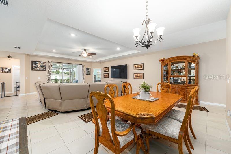 5077 Northeast 16th Street Ocala, FL 34470 - Photo 18 of 47 a view of a dining room with furniture and a chandelier