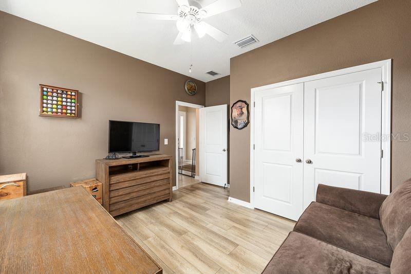 5077 Northeast 16th Street Ocala, FL 34470 - Photo 29 of 47 a bedroom with furniture and a flat screen tv