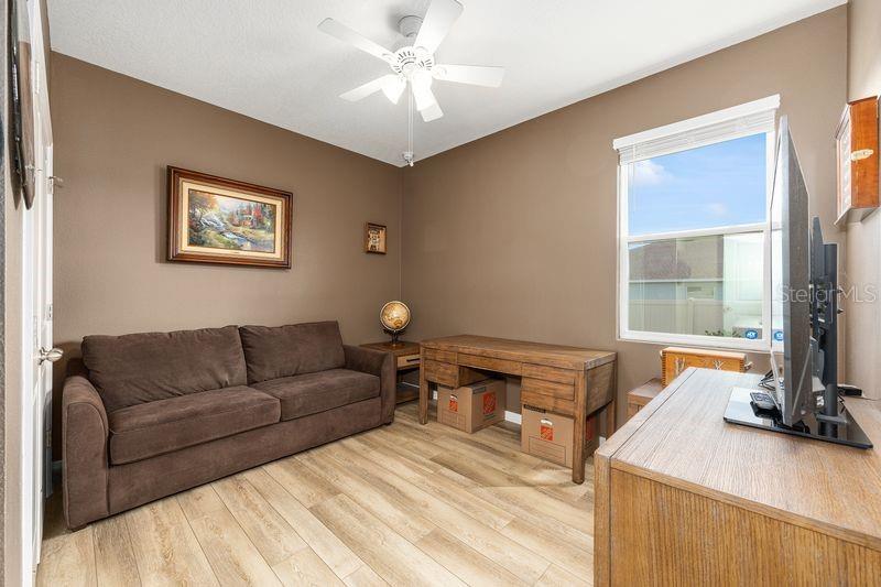 5077 Northeast 16th Street Ocala, FL 34470 - Photo 30 of 47 a living room with furniture and a flat screen tv