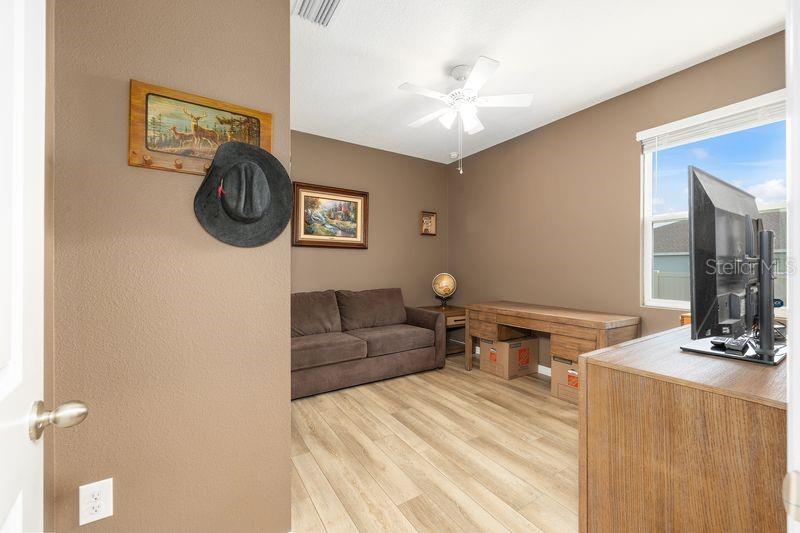 5077 Northeast 16th Street Ocala, FL 34470 - Photo 31 of 47 a bedroom with a bed and a chandelier