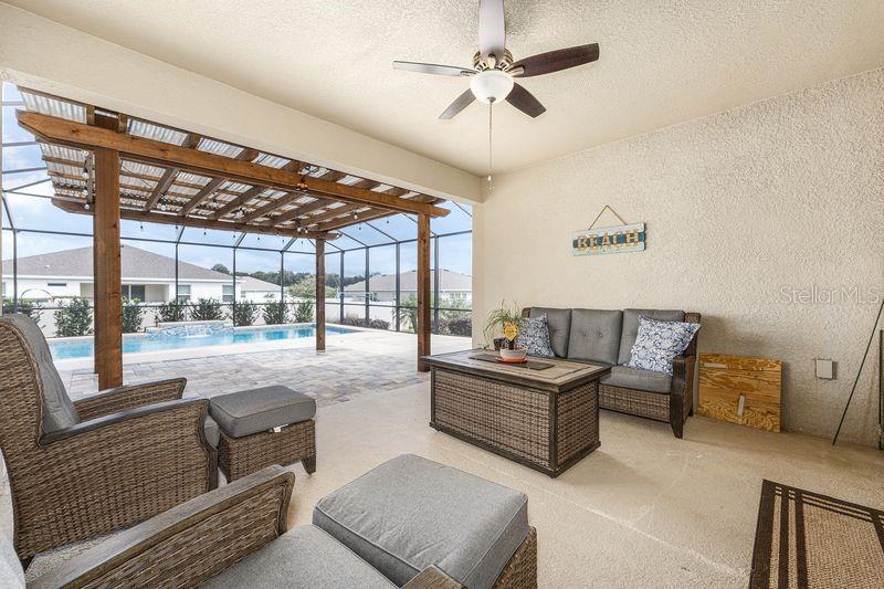 5077 Northeast 16th Street Ocala, FL 34470 - Photo 37 of 47 a living room with furniture and a floor to ceiling window