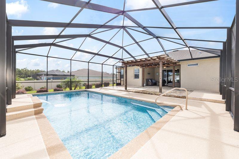 5077 Northeast 16th Street Ocala, FL 34470 - Photo 41 of 47 a view of a swimming pool with a patio