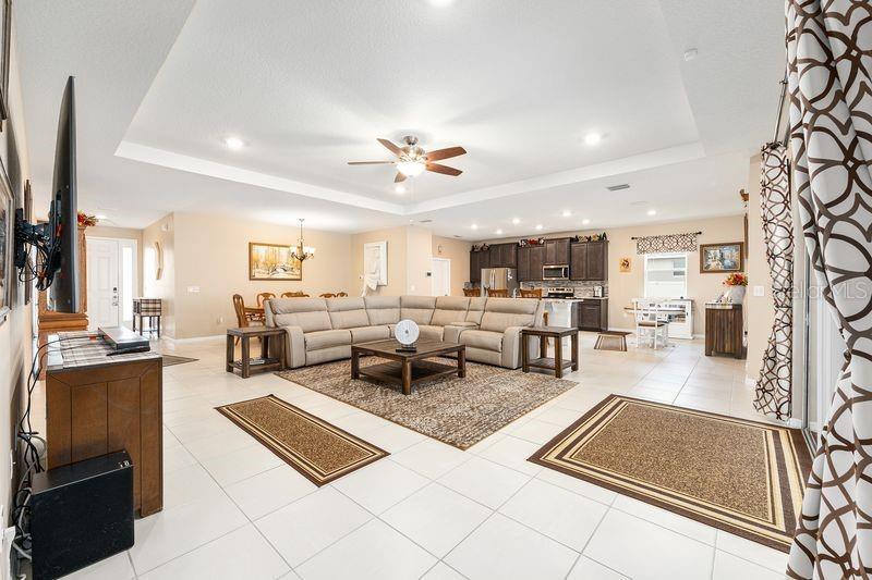 5077 Northeast 16th Street Ocala, FL 34470 - Photo 7 of 47 a living room with lots of furniture and kitchen view