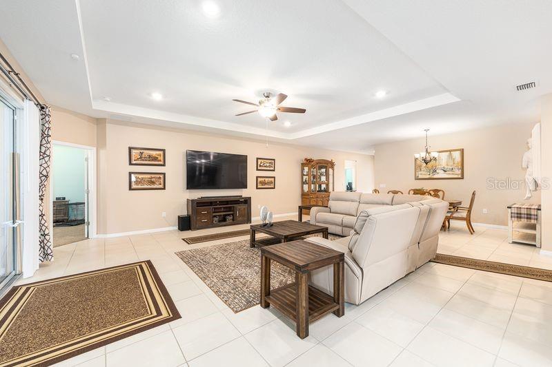 5077 Northeast 16th Street Ocala, FL 34470 - Photo 10 of 47 a living room with furniture and a flat screen tv