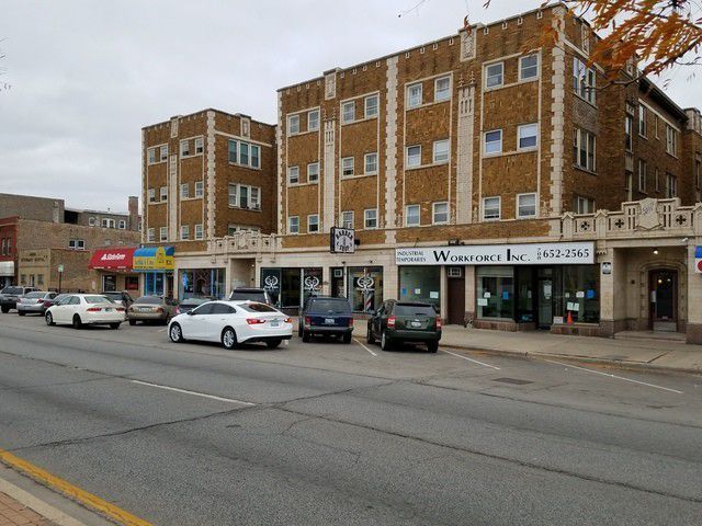 5017 West Cermak Road, Unit 7 Cicero, IL 60804 - Photo 1 of 6 a view of building with cars parked