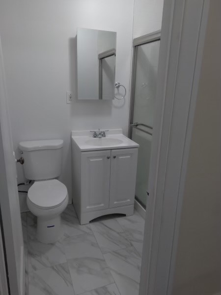 5017 West Cermak Road, Unit 7 Cicero, IL 60804 - Photo 5 of 6 a bathroom with a toilet sink and mirror