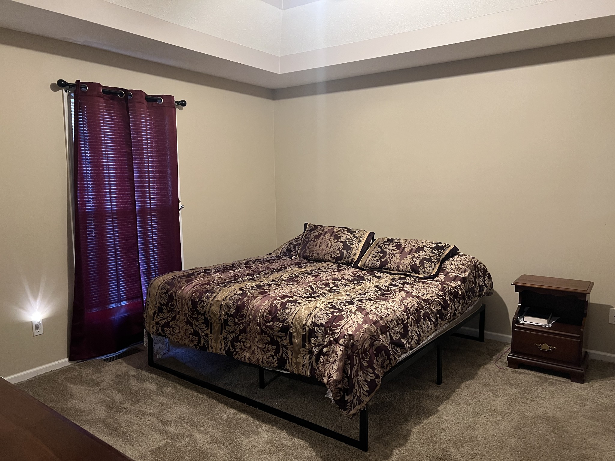 251 Walton Chapel Road Lafayette, TN 37083 - Photo 7 of 16 a bed sitting in a bedroom next to a cabinet and a lamp