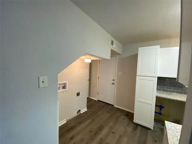 an empty room with wooden floor