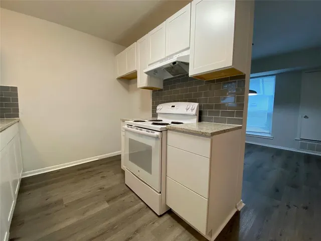 a kitchen with cabinets and appliances