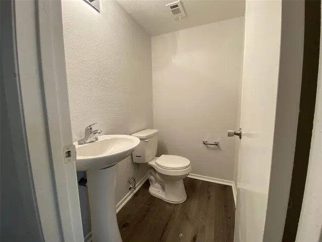 a bathroom with a sink and mirror with toilet